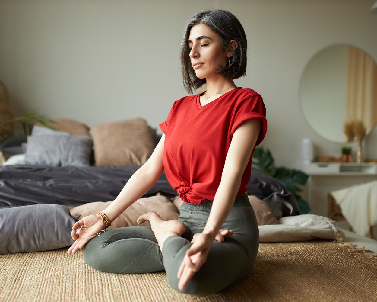 Person meditating outdoors for stress relief